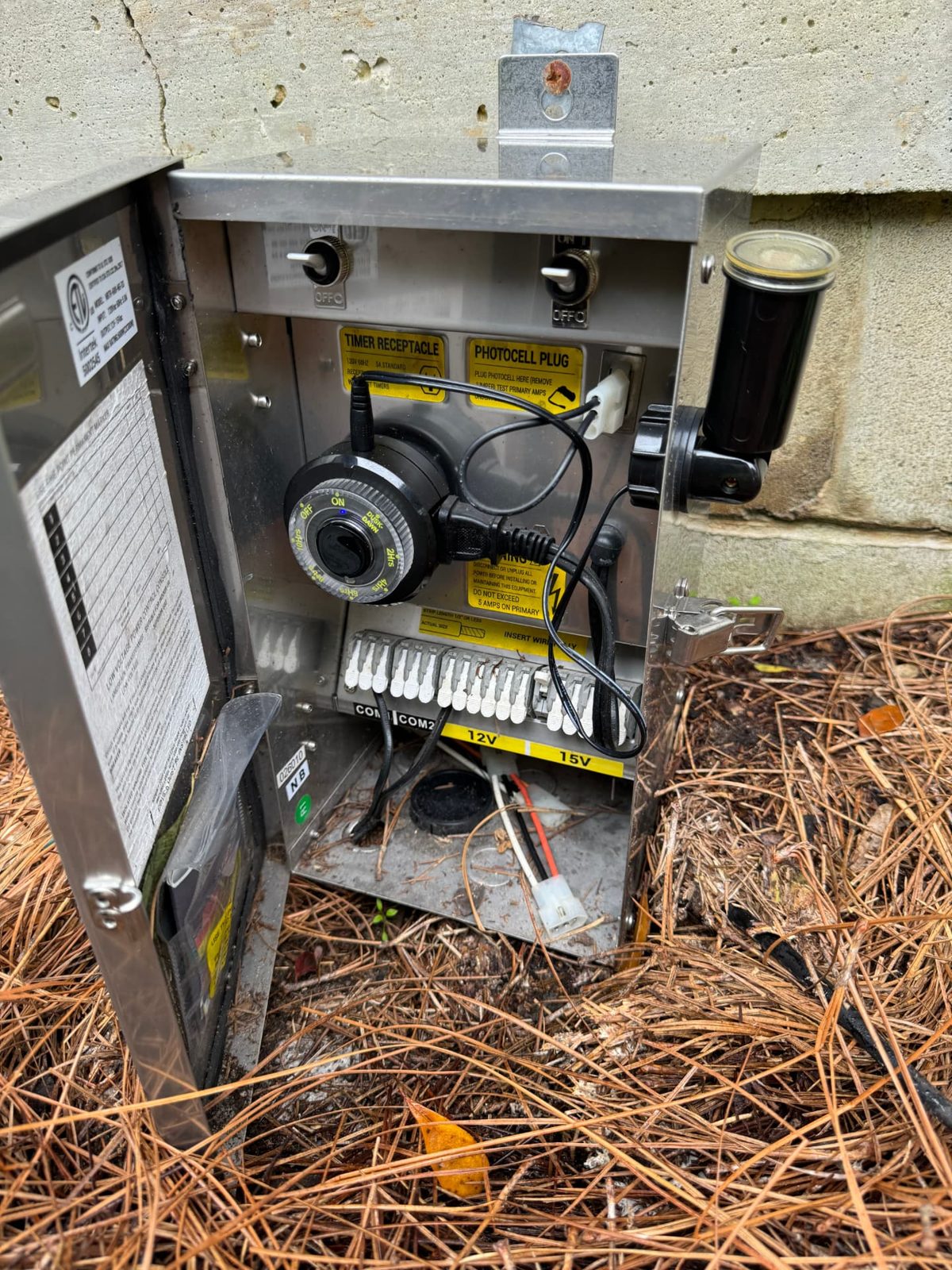 Outdoor control enclosure with timer and photocell devices